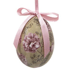 Sierlijk hangend paasei met paarse bloemenprint op een vintage beige ondergrond met roze lint