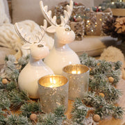 Glazen theelichthouder met gouden dennentakken