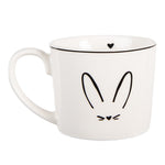 Witte keramische mok met minimalistisch konijnengezicht voor de paastafel